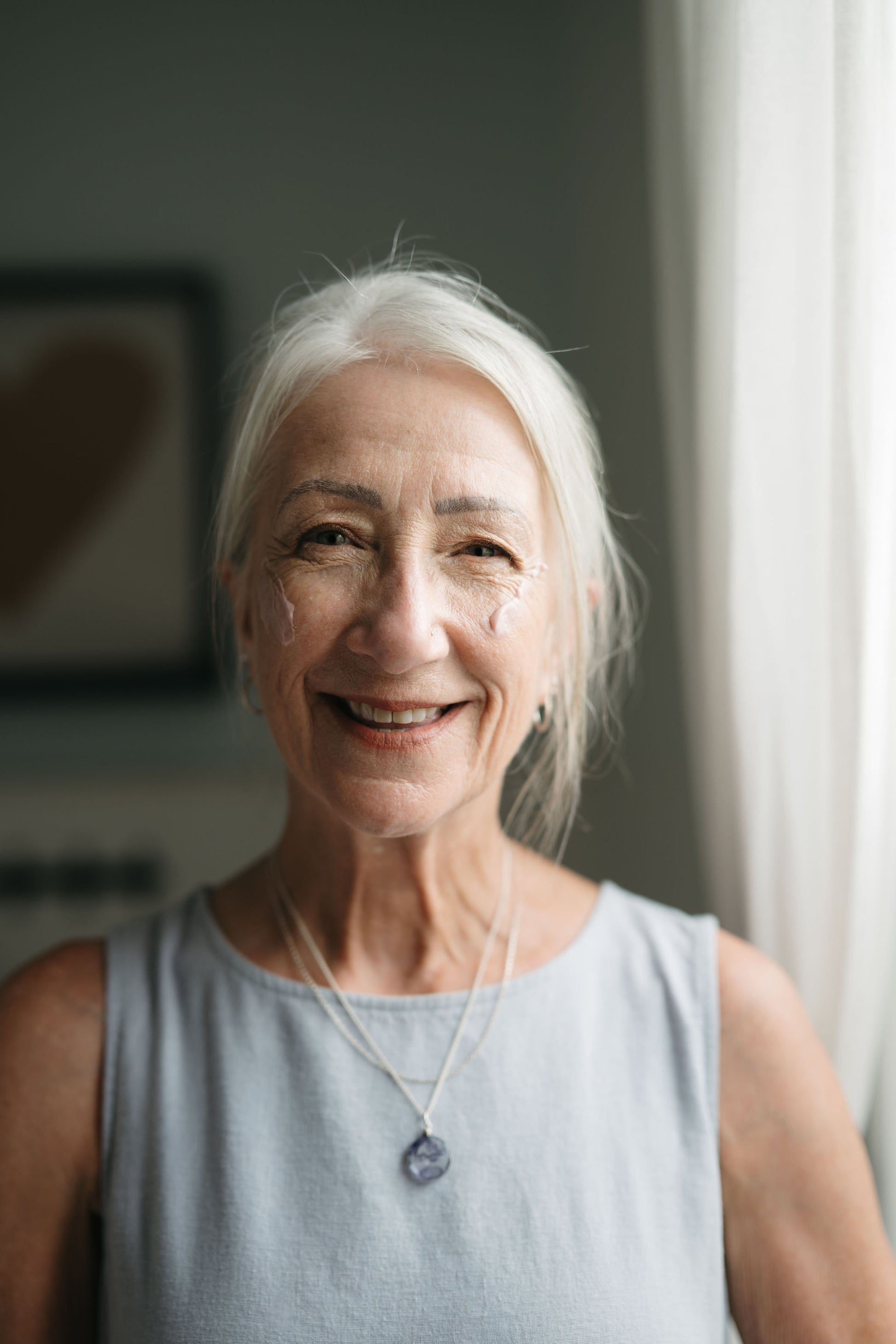 Smiling older woman with gray hair in a casual setting